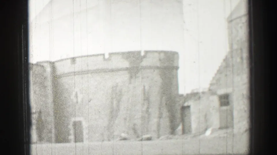 A rounded masonry section and adjacent stone buildings appear in the final 1952 Scotland frame.
