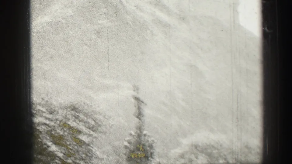 Final frame shows the hazy Edinburgh Castle hillside with a small pointed tower-like form near the lower edge and dark window framing.