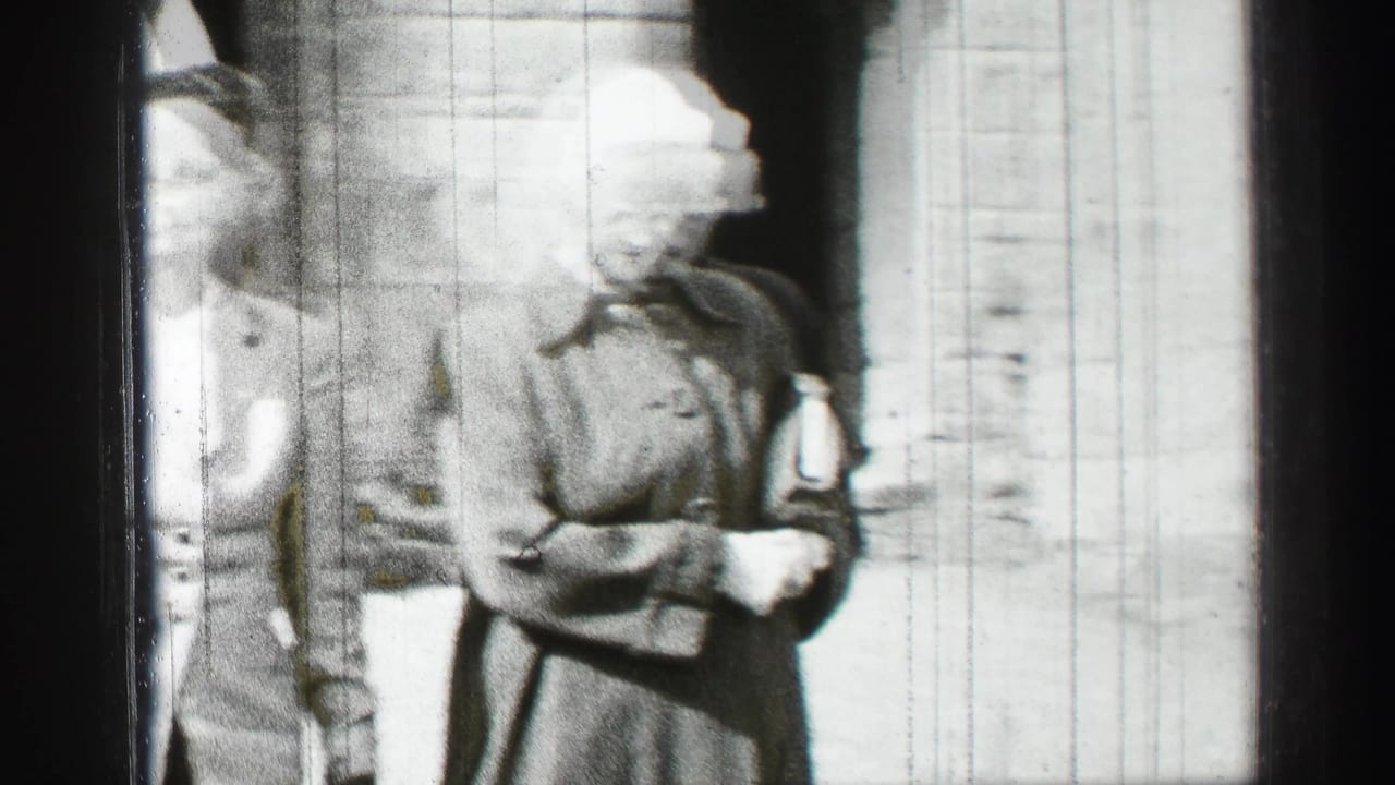 Two women walking close to camera beside a stone wall and dark archway.
