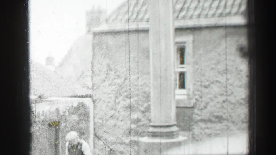 1952 Edinburgh exterior showing stone walls, a column, rooflines and a partly visible person near the building.