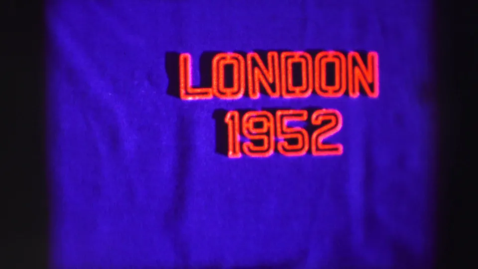Centered 1952 title-card frame with London 1952 in red outlined letters on a purple cloth-like background.