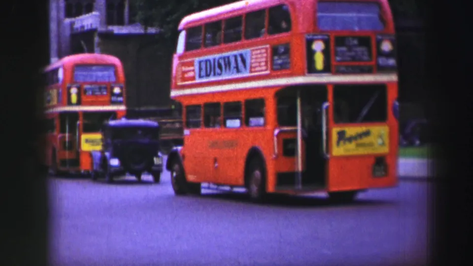 1952 Edinburgh street view with red double-decker buses, a dark car, stone buildings, and a visible EDISWAN advertisement.