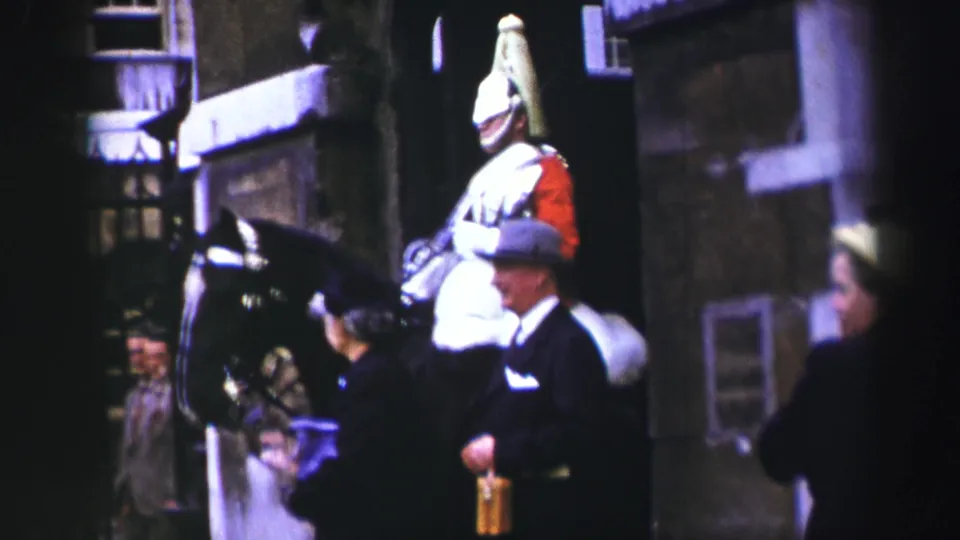 The closing frame shows the ceremonial rider and horse with visitors nearby in 1952 Edinburgh home-movie color footage.