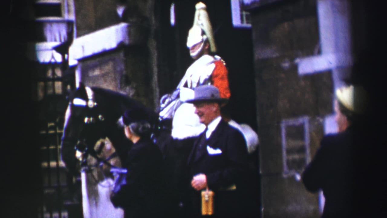 Mounted ceremonial figure beside a black horse with suited pedestrians nearby.