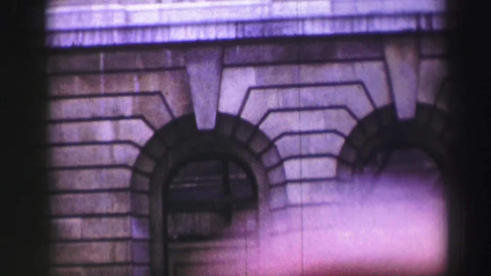 1950s Edinburgh architectural detail showing arched masonry entrances and a projecting stone ledge in soft 8mm focus.