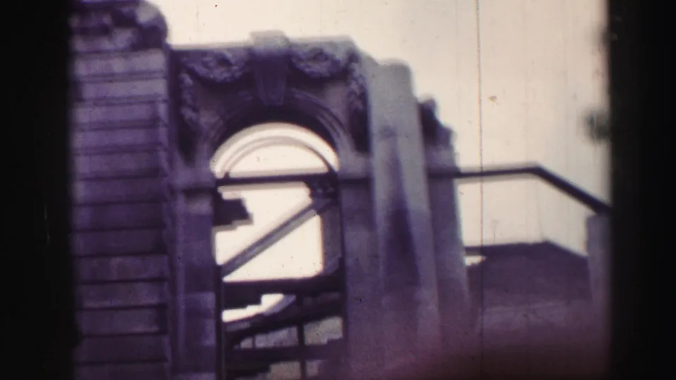 1952 Edinburgh frame with a rounded stone arch, heavy masonry, railings, and dark structural beams inside the opening.