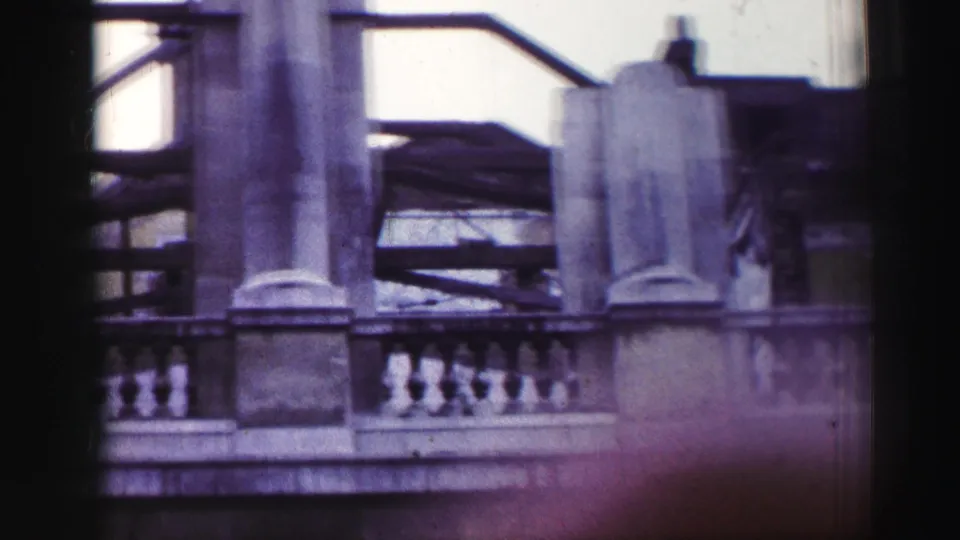 1952 Edinburgh frame showing gray stone columns and balustrade with railings and shadowed upper architectural details.