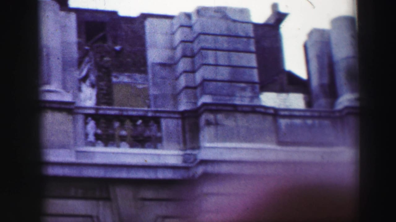 Stone balcony corner with rusticated masonry, columns, and open upper structure.
