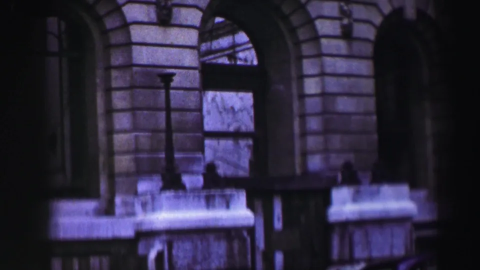 1952 8mm view of arched windows and stone balcony rail on a Scottish historic building exterior.