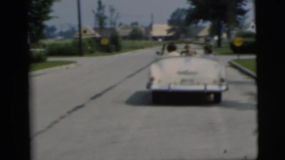 White convertible seen from behind on a Pennington, New Jersey street in supplied 1955 home-movie footage.