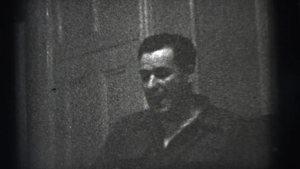 After drinking, the man appears with his glass lowered or out of view in the same dim 1956 New York City home interior.