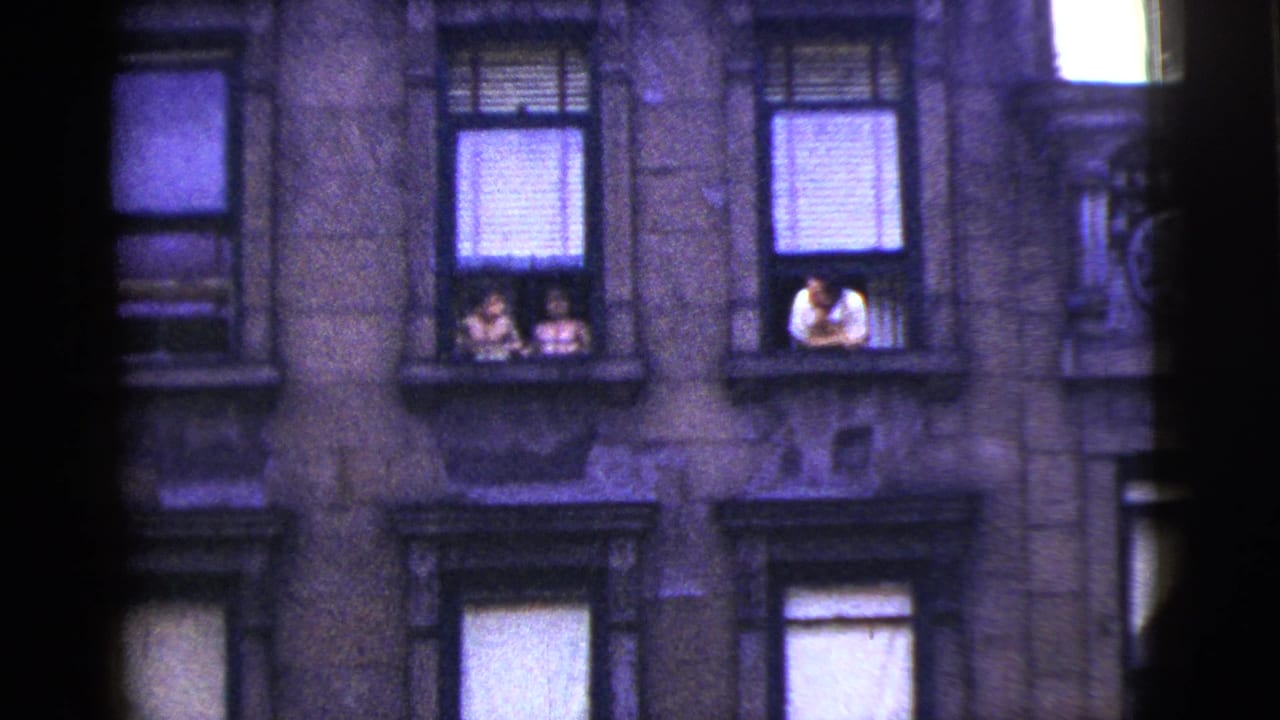 1956 New York City frame of apartment windows, with two people at one window and a person in a white shirt leaning from another.