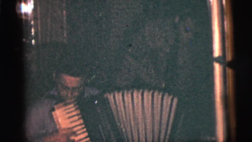 The final frame keeps the player low and partly cropped while the accordion bellows and dark interior remain visible.
