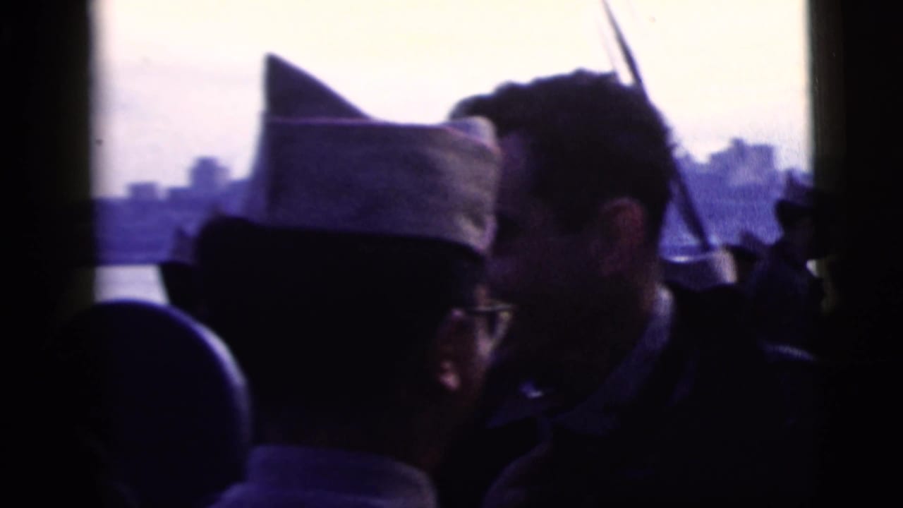 Uniformed men and passengers silhouetted against a hazy city skyline from a boat.