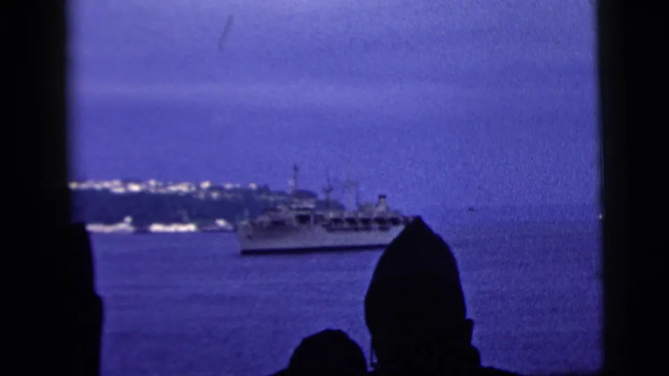 1958 New York City harbor footage showing a large vessel offshore with silhouetted viewers at the lower edge of the frame.