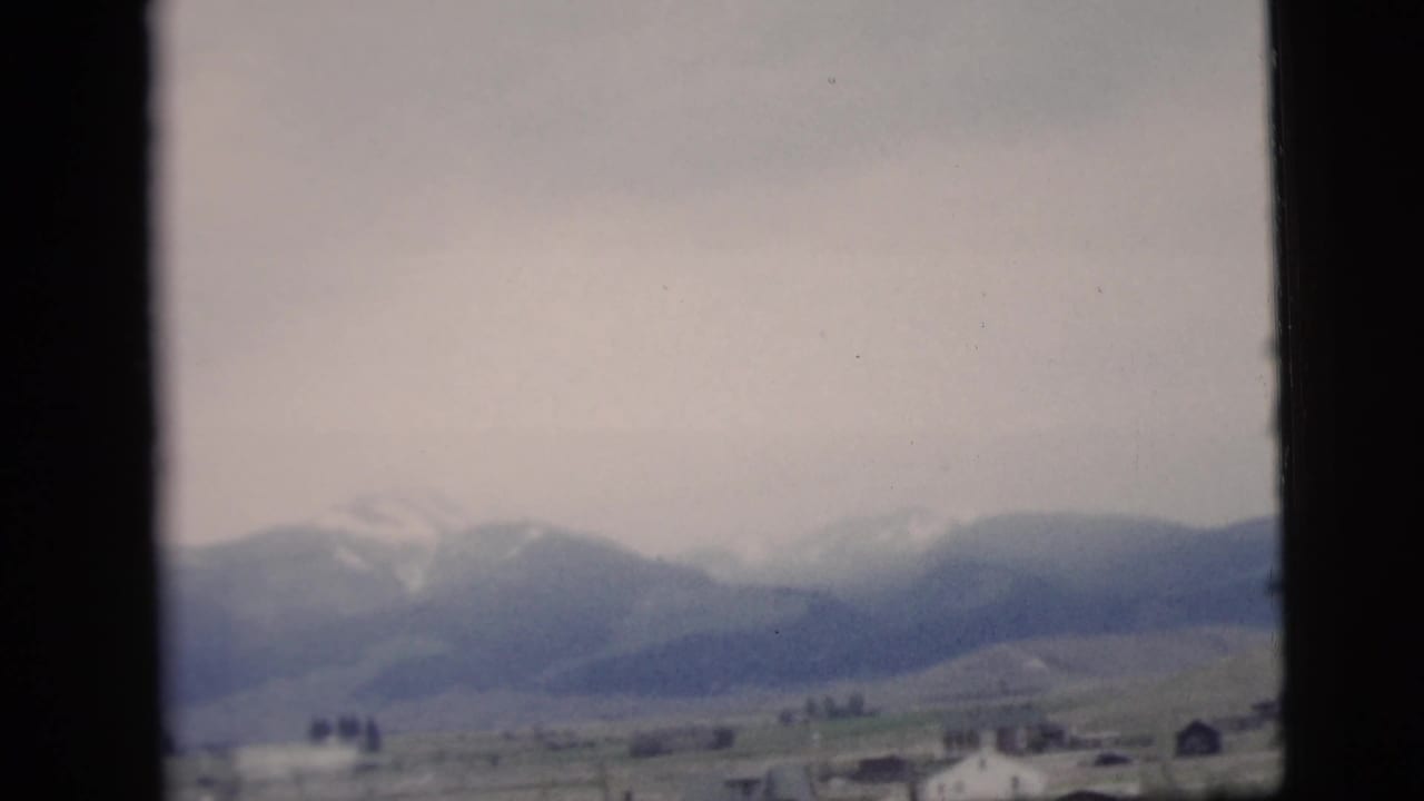 Soft 8mm view of distant hills and open land, likely part of a travel sequence associated with the 1958 New York City clip metadata.