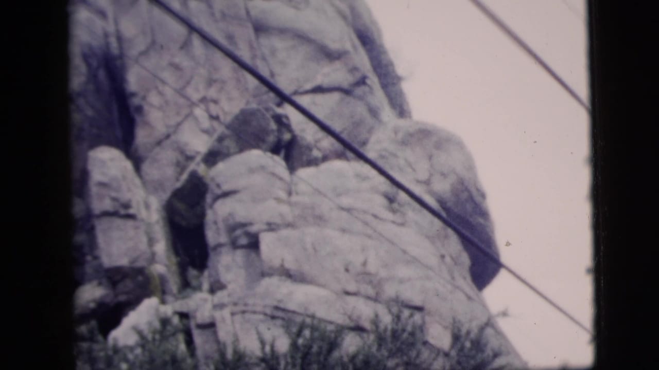 Tall rock face with cables crossing the upper frame.