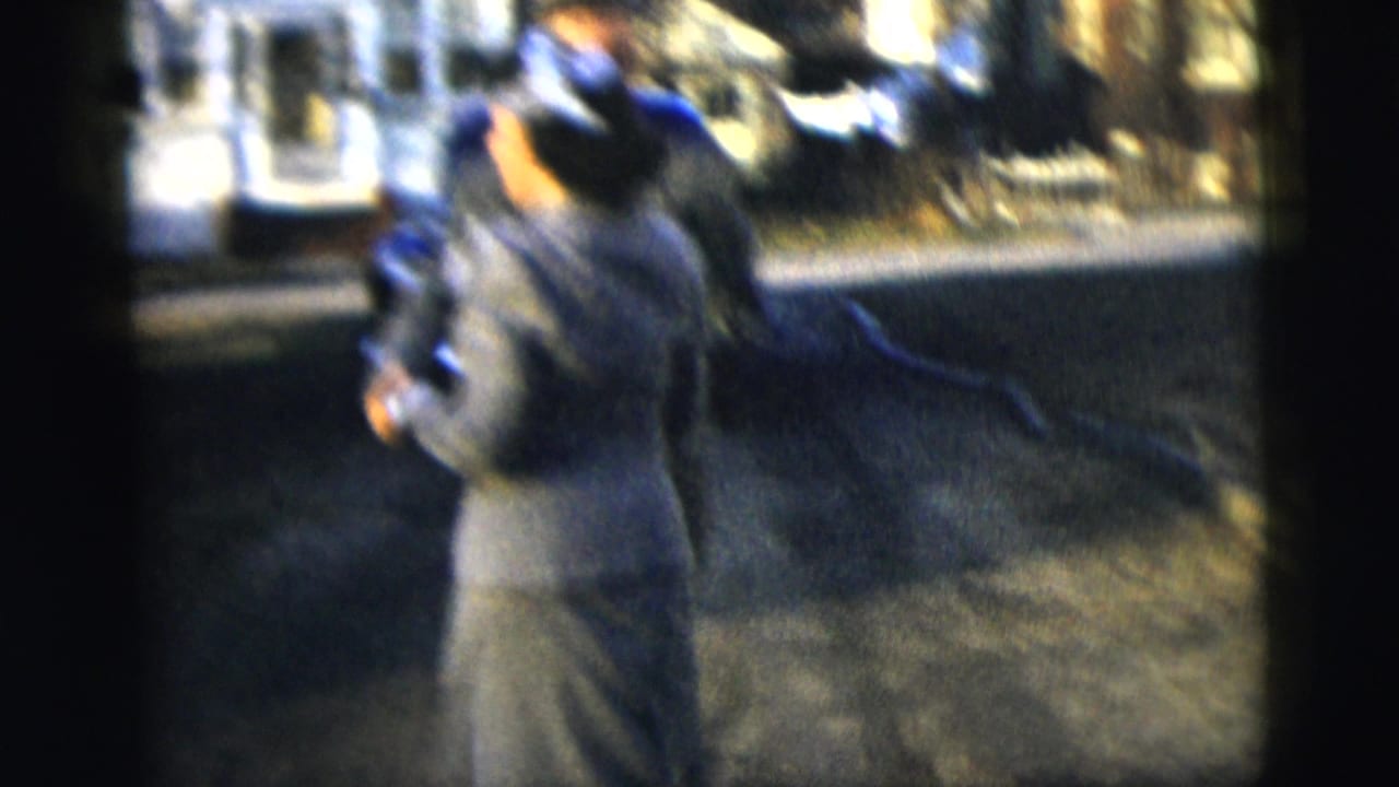 The woman turns during the dance as the man remains partly visible in soft 1958 New York 8mm footage.
