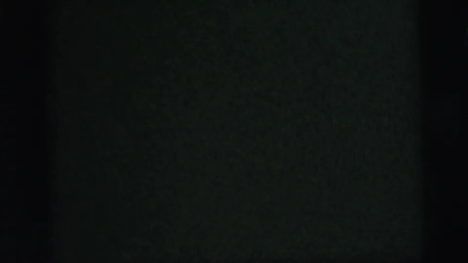 The camera drops below the fixtures, leaving a dark textured interior surface and only faint edge light from the ceiling area.