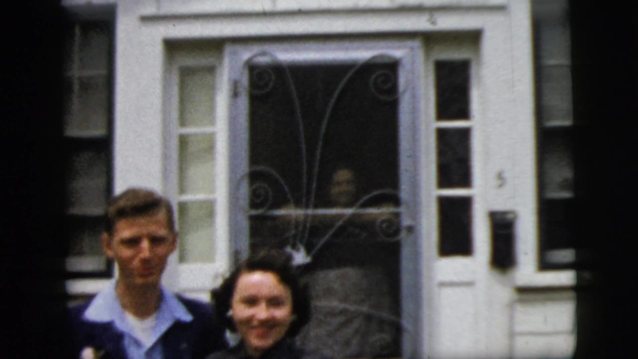 Couple posing in front of a decorative screen door.