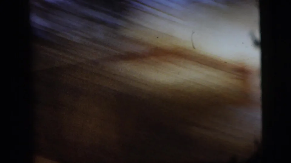 Motion-blurred 8mm frame from a handheld camera movement within the New York City home-movie clip.