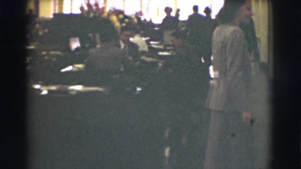 The final frame shows the woman at the right edge of the Saint Louis office interior, with workers and bright windows in the background.
