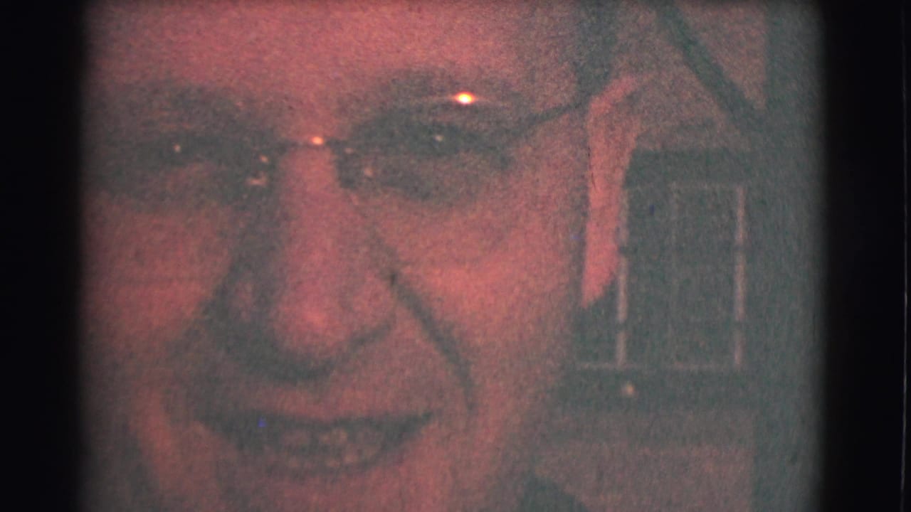 Close 1959 Saint Louis home-movie frame of an adult woman in glasses smiling toward the camera.