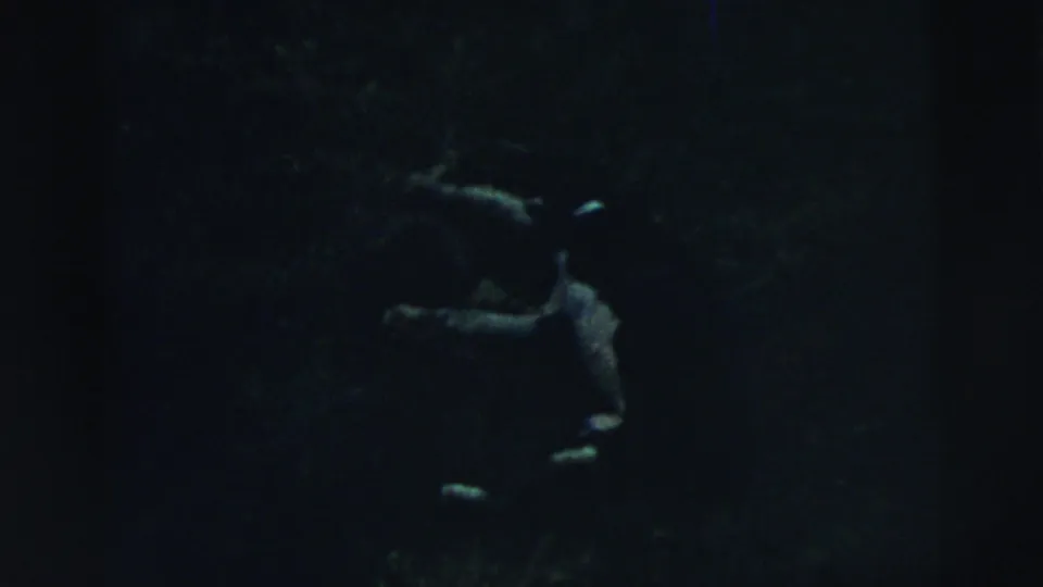 The clip ends on a very dark, blurry 8mm frame with indistinct shapes and little readable detail.
