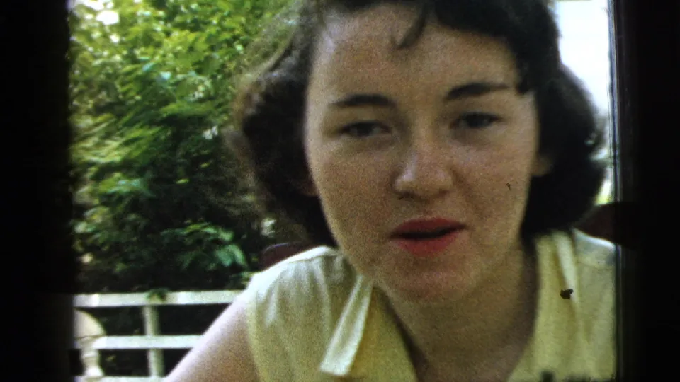 Young woman appears to speak or react to the camera in 1961 Camden, New Jersey 8mm footage.