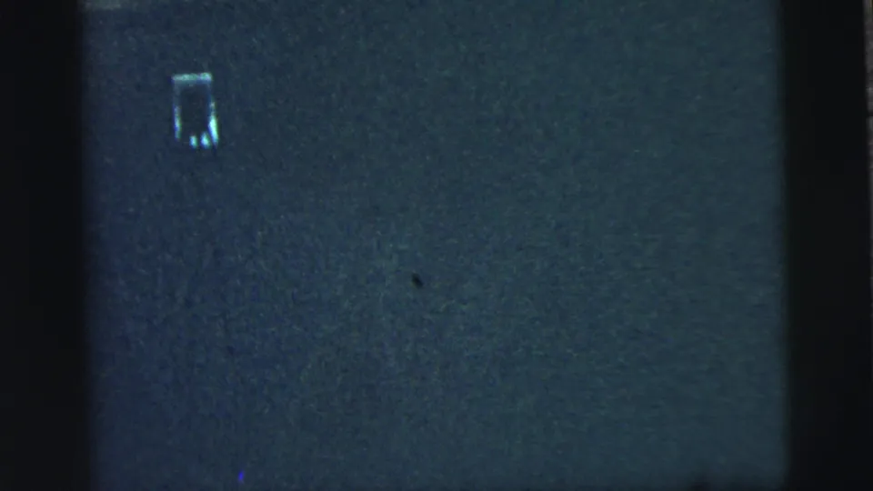 The final frame shows blue-gray 8mm leader or exposed film texture with a small pale mark near the upper area.