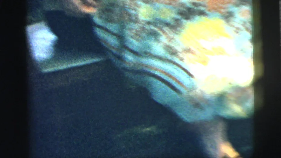The final frame becomes a blurred close view of the woman's yellow blouse and dark skirt as the handheld camera shifts in bright sun.