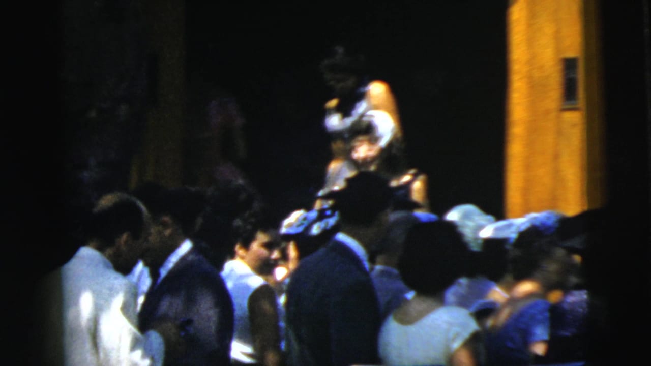 Formally dressed guests stand near the church entrance.