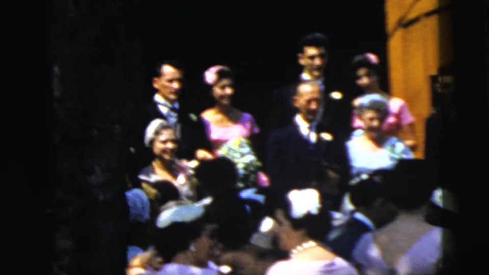 Camden wedding group outside church doors in 1961, with older guests, attendants, bouquets, and a dense foreground crowd.