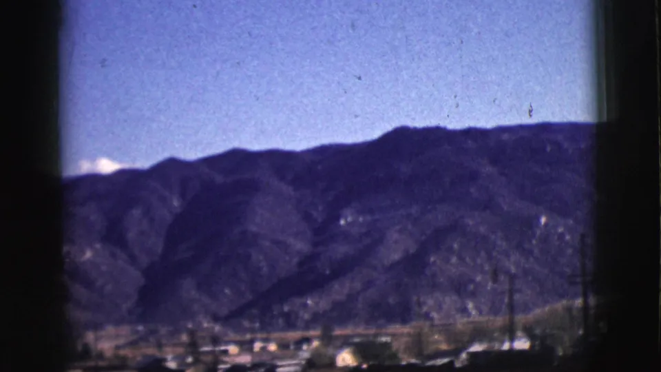 The final frame shows Clarkdale buildings and utility poles below a purple-blue mountain ridge under clear sky in 1961 footage.