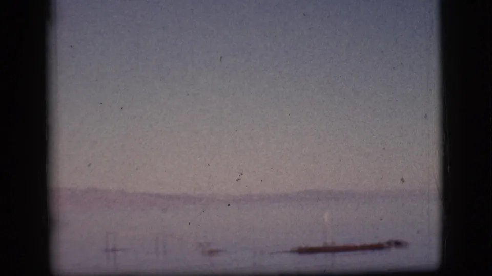 Hazy 8mm frame of a lake or reservoir near the supplied Clarkdale, Arizona location, with distant shoreforms barely visible.
