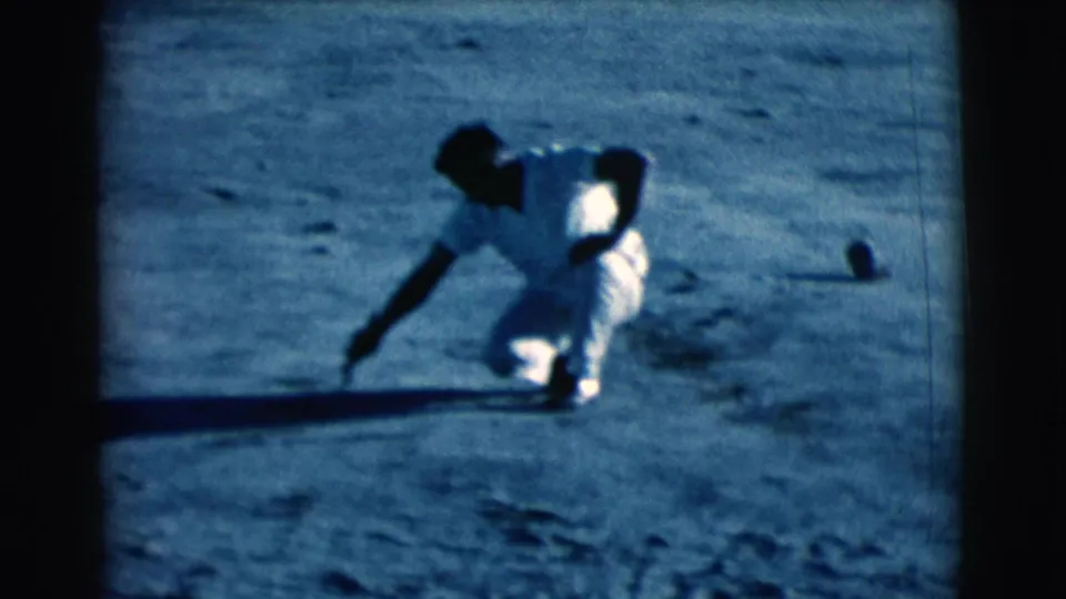 At the end of the short clip, the man stays crouched in the Clarkdale field, arm stretched toward the dirt under late-day shadows.