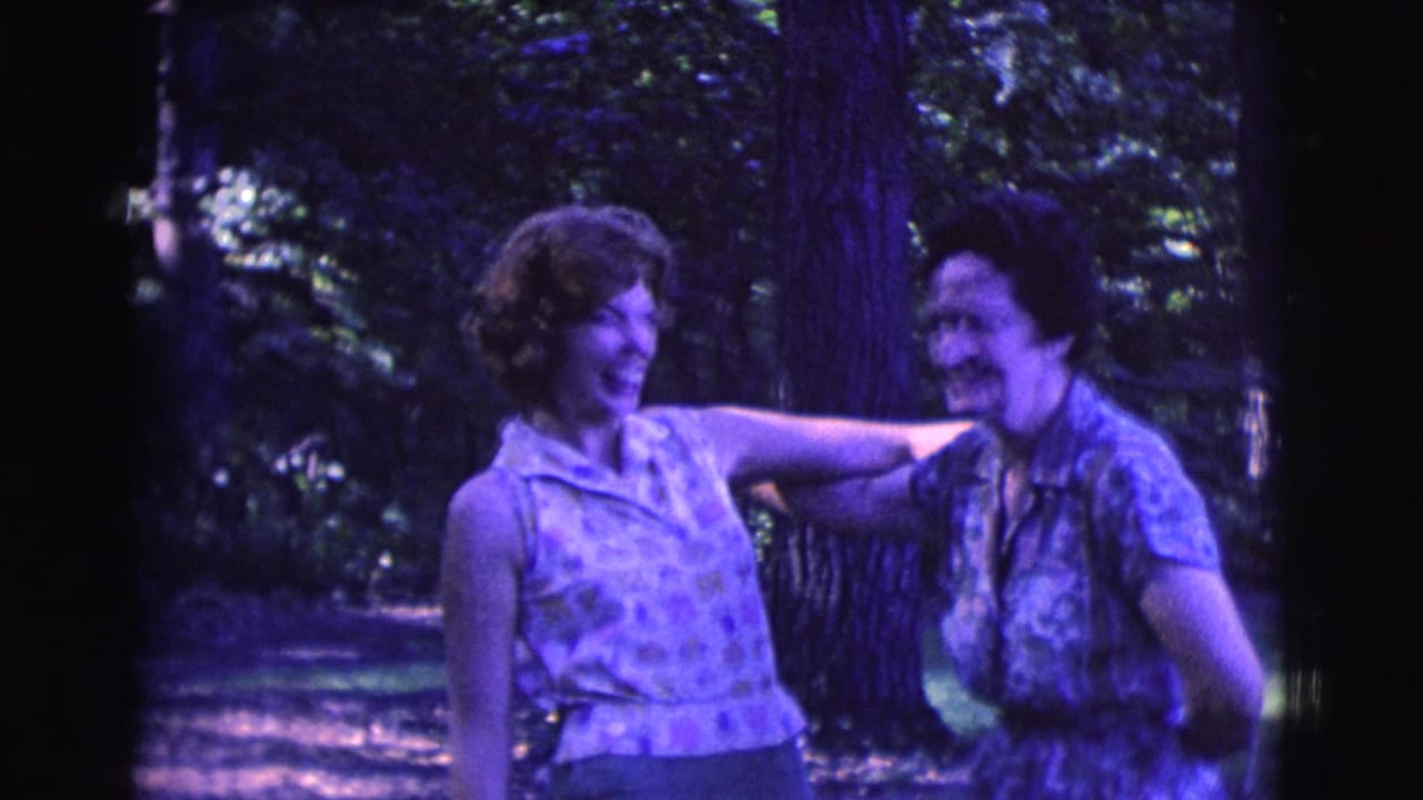 Two adult women smile and laugh near trees in Clarkdale, Arizona, in 1961 8mm home-movie footage.