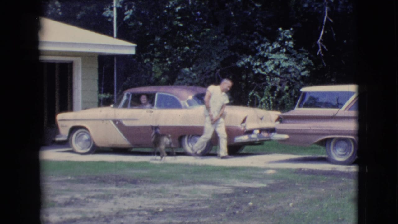 In 1961 Clarkdale, Arizona home-movie footage, a man walks from a two-tone sedan toward a station wagon while a small dog follows.