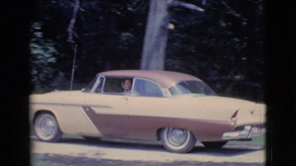 1961 Clarkdale, Arizona frame showing the side of the two-tone car with an adult driver visible at the window.