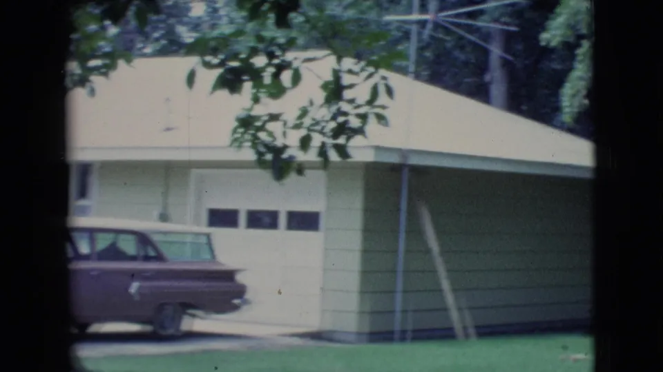 Clarkdale, Arizona frame showing a light-sided garage and a dark 1960s-era station wagon parked in the driveway.