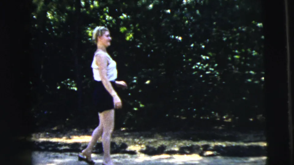 The 1962 Camden frame shows a teenage girl in profile on a road, with trees and dappled summer light behind her.