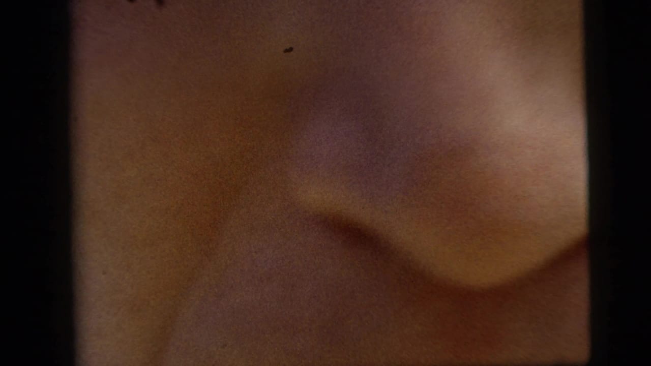 Very close, soft-focus view of a person's face or skin tone filling the frame.