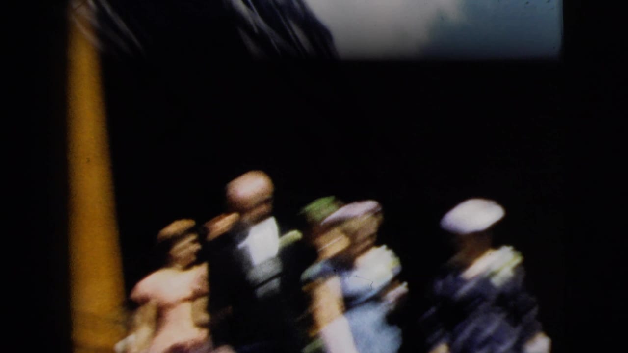 1962 Camden wedding party begins to exit near a dark church doorway, with suited men and women in formal dresses and hats.