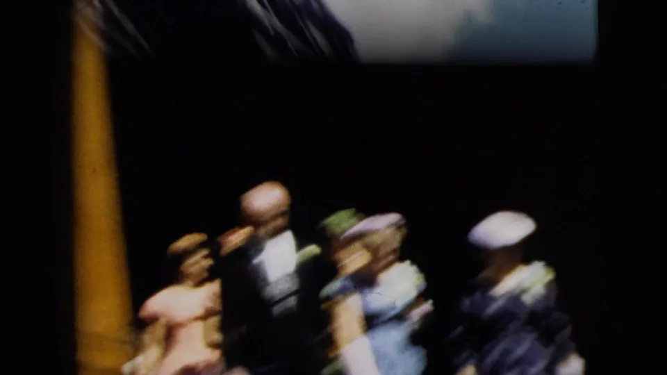 1962 Camden wedding party begins to exit near a dark church doorway, with suited men and women in formal dresses and hats.