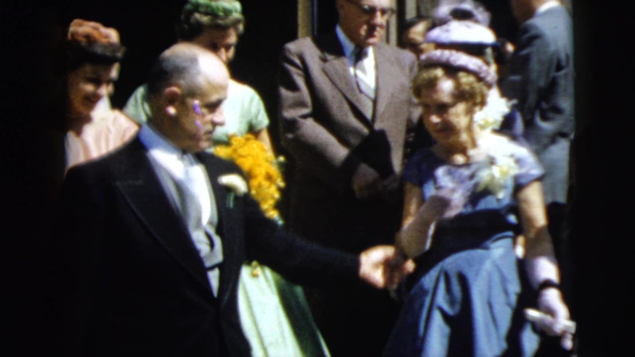 A 1962 Camden formal gathering shows suited men leading women in pastel dresses with yellow bouquets down steps.