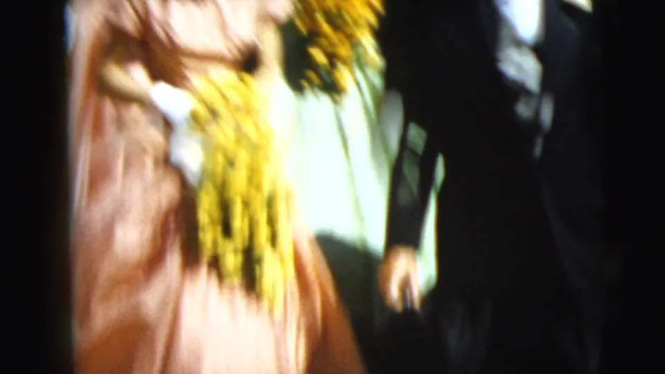 Motion blur emphasizes the handheld 8mm view as the formal group continues down the steps in Camden in 1962.