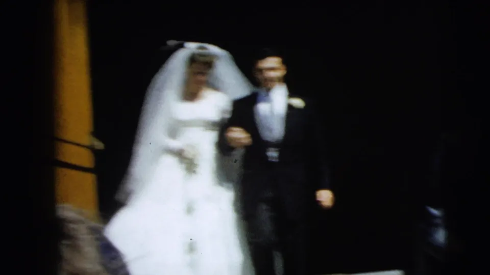 A softer, motion-blurred frame shows the bride and groom still arm-in-arm on the steps, with a wooden column and dark doorway behind them.