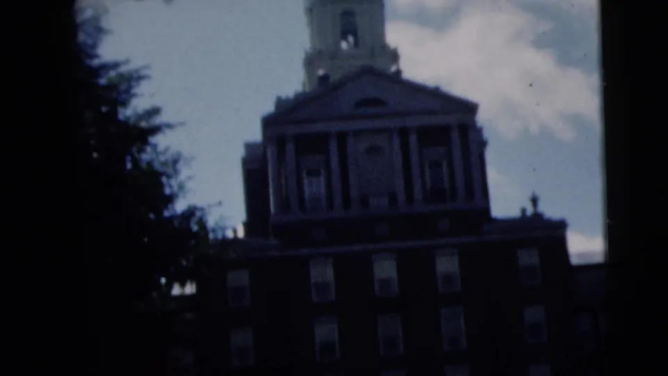 1962 Camden, New Jersey 8mm frame showing the church facade, bell tower, columns, windows, and trees under uneven exposure.