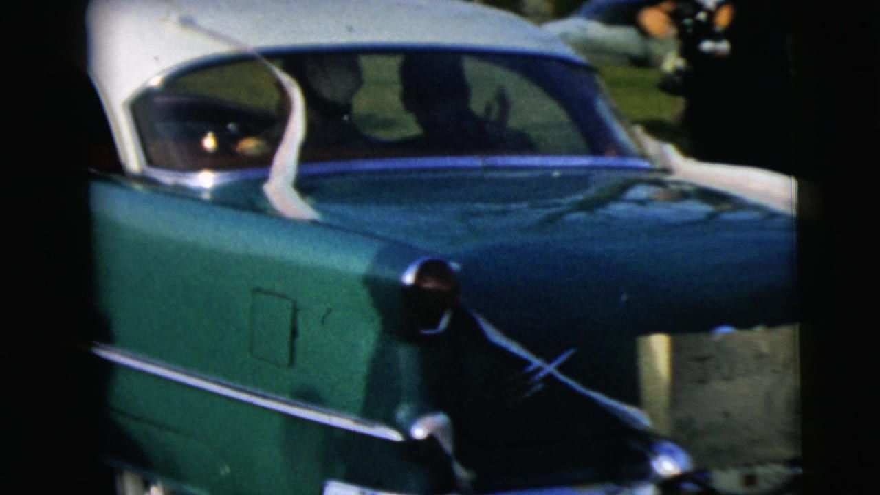Close rear view of a green-and-white sedan with chrome trim, filmed from another vehicle in Camden, New Jersey, according to clip metadata.