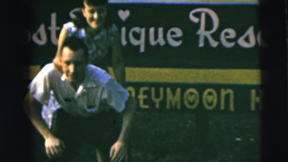 Final frame shows the man carrying the woman piggyback, both partly framed against the honeymoon resort sign.